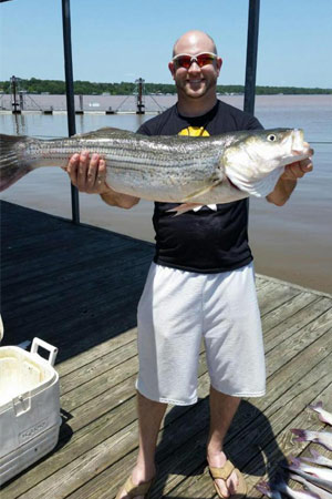 Tanner Naeher with a 16.5lb striper at Lake Texoma after a trip with Wylie Guide Services